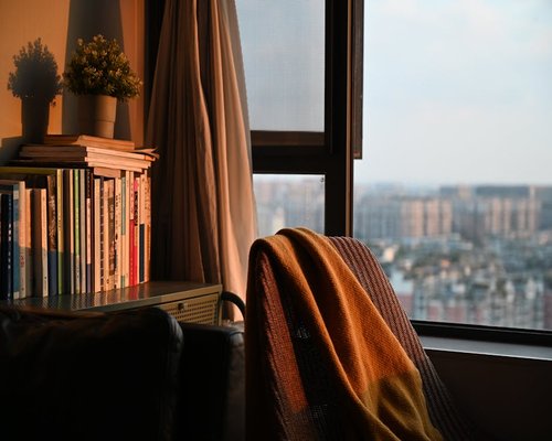 Comfortable reading corner with a book and natural sunlight
