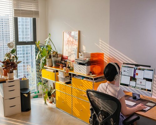 Person working at a modern home office desk in Mexico City with natural light